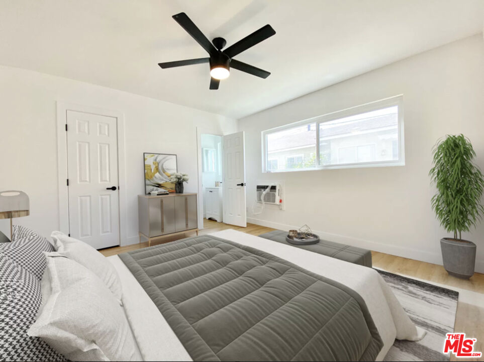 3824 Keystone Avenue, Unit 2 Culver City, CA 90232 - Photo 8 of 10 a bedroom with a large bed and a chandelier