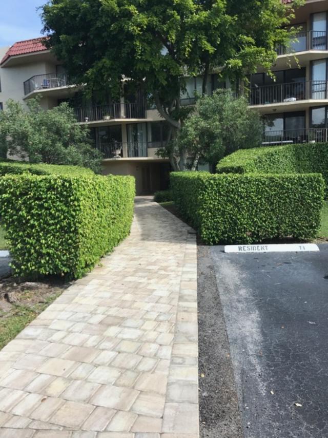 799 Jeffery Street, Unit 308 Boca Raton, FL 33487 - Photo 1 of 9 a front view of a house with a yard