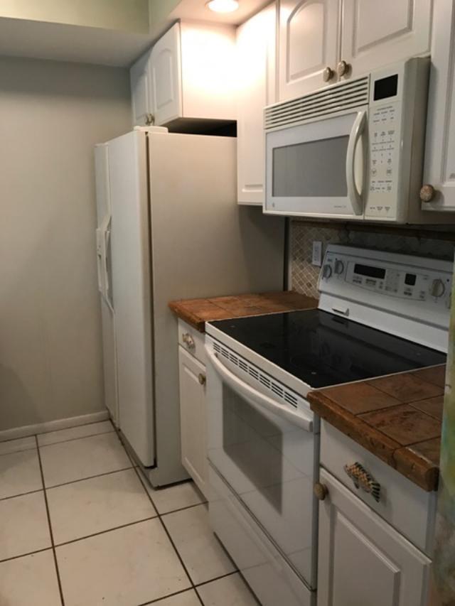 799 Jeffery Street, Unit 308 Boca Raton, FL 33487 - Photo 5 of 9 a white stove top oven sitting inside of a kitchen