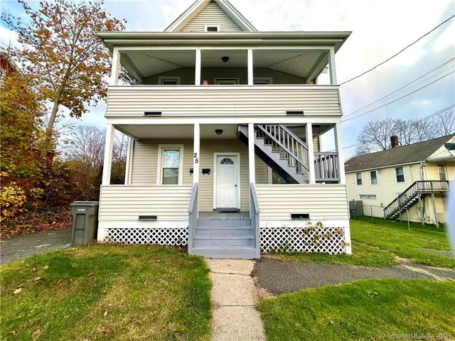 a view of a white house with a yard