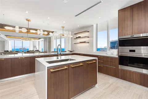 a spacious bedroom with a bed and large window