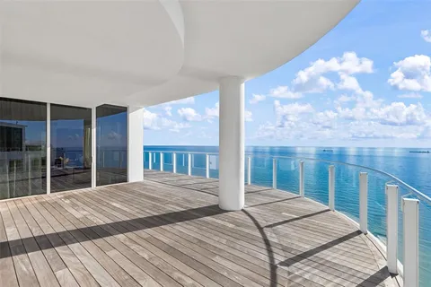 a kitchen with cabinets and chairs