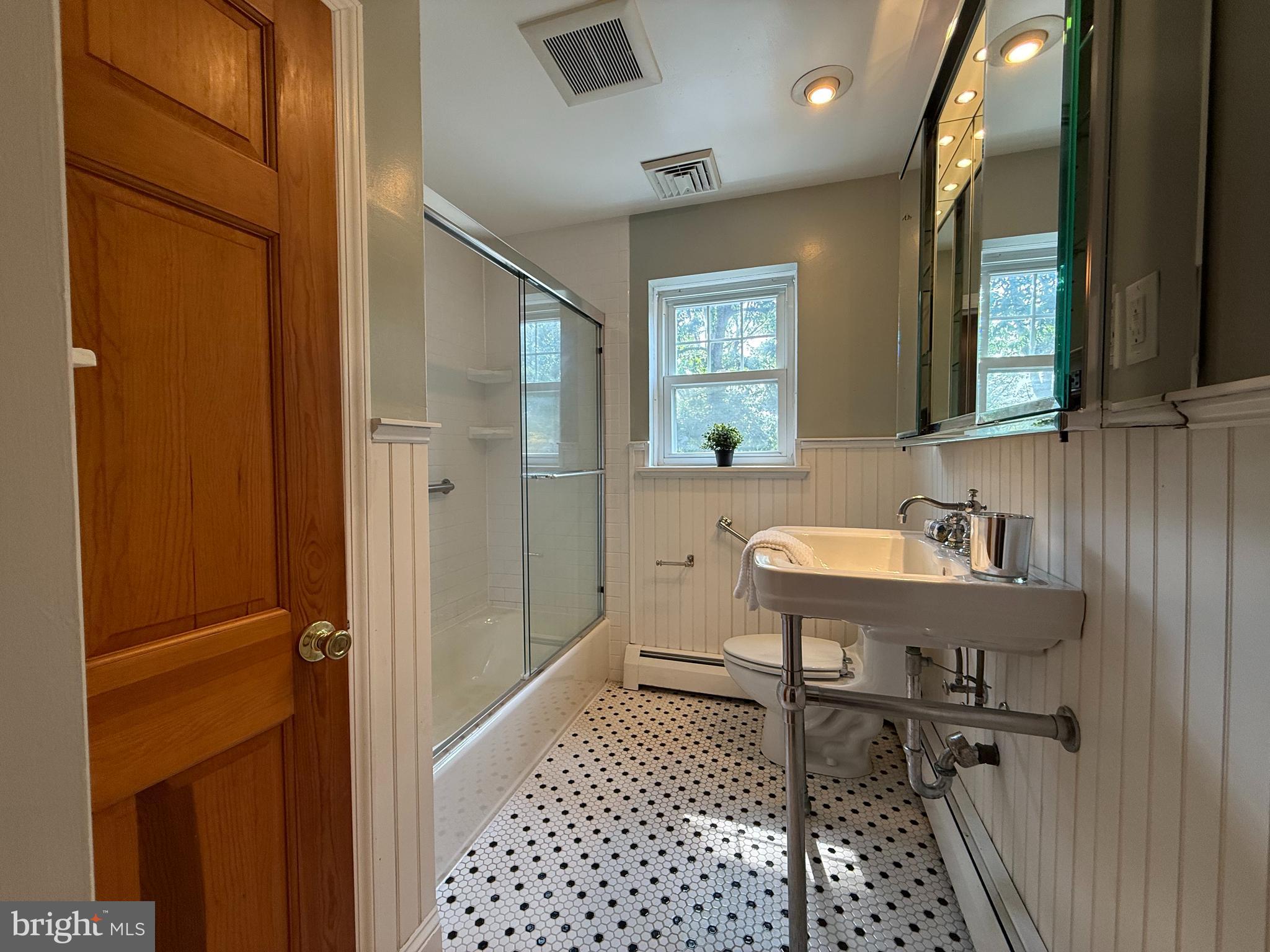 325 Greene Road Berwyn, PA 19312 - Photo 39 of 50 a bathroom with a sink a mirror and a shower
