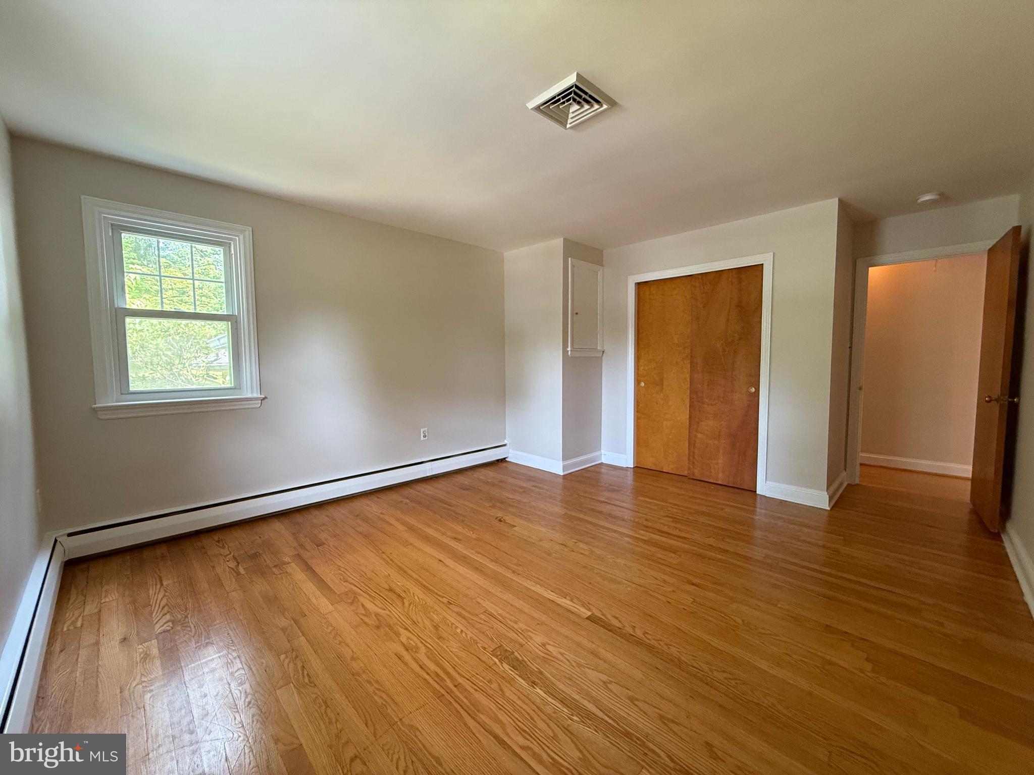 325 Greene Road Berwyn, PA 19312 - Photo 44 of 50 a view of an empty room with wooden floor and a window