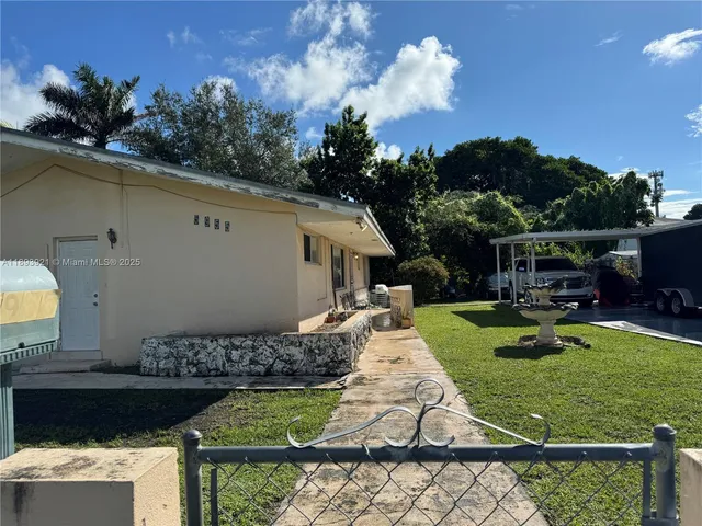 a view of a house with backyard tub and sitting area