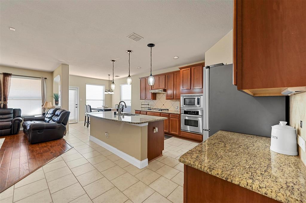 14815 Frisco Ranch Drive Little Elm, TX 75068 - Photo 40 of 40 a kitchen with stainless steel appliances granite countertop a sink dishwasher stove and refrigerator