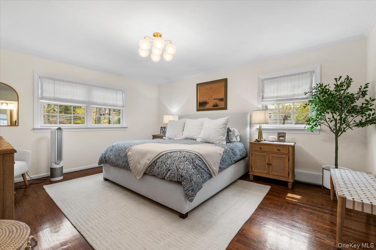 8 Heritage Court Cold Spring Harbor, NY 11724 - Photo 19 of 38 a spacious bedroom with a bed and a couch
