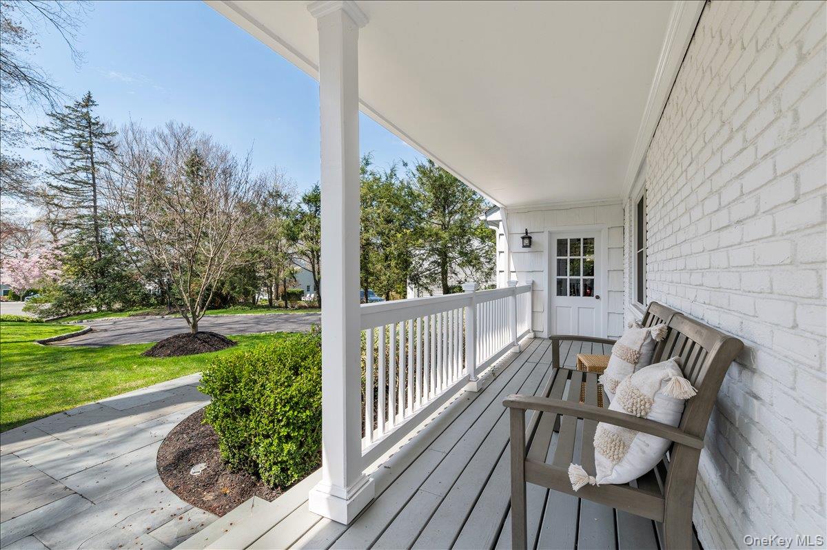 8 Heritage Court Cold Spring Harbor, NY 11724 - Photo 2 of 38 a view of balcony with wooden floor and outdoor seating