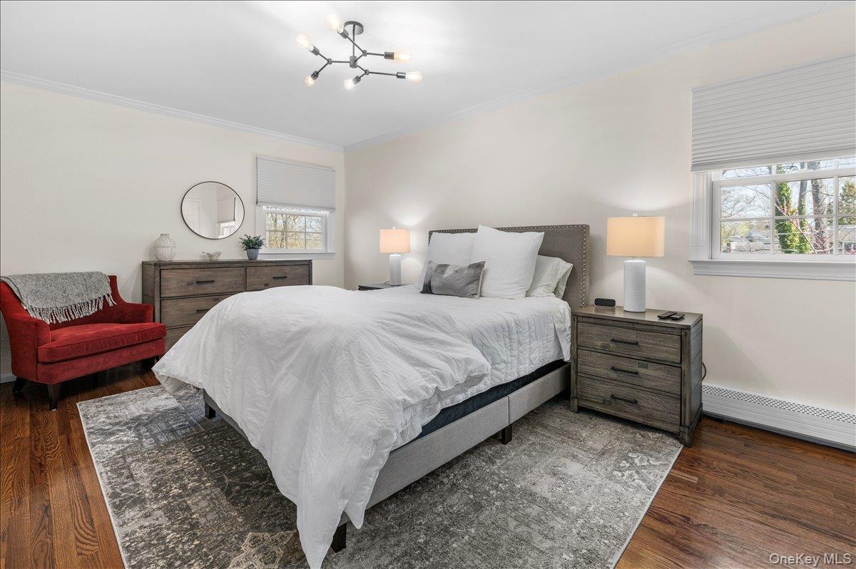 8 Heritage Court Cold Spring Harbor, NY 11724 - Photo 24 of 38 a bed room with a bed and a lamp