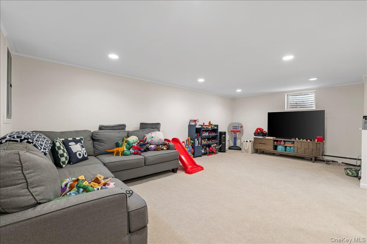 8 Heritage Court Cold Spring Harbor, NY 11724 - Photo 25 of 38 a living room with furniture and a flat screen tv