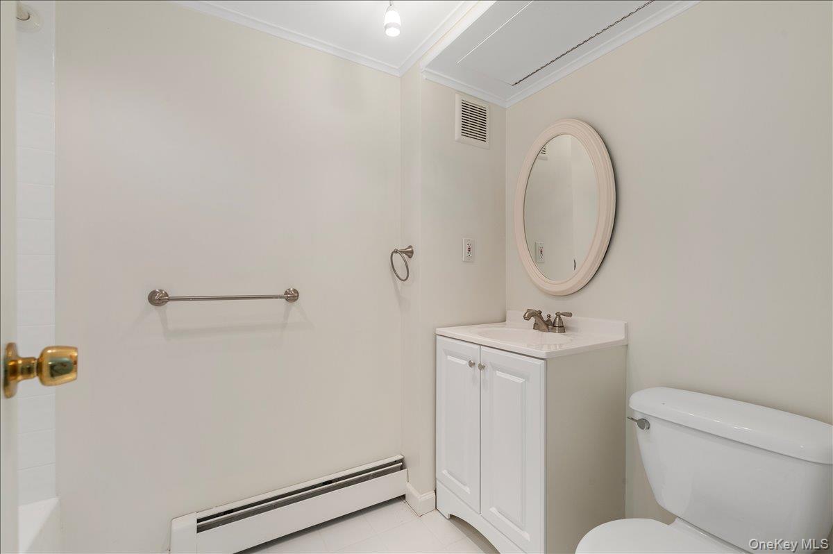 8 Heritage Court Cold Spring Harbor, NY 11724 - Photo 28 of 38 a bathroom with a toilet a sink and mirror