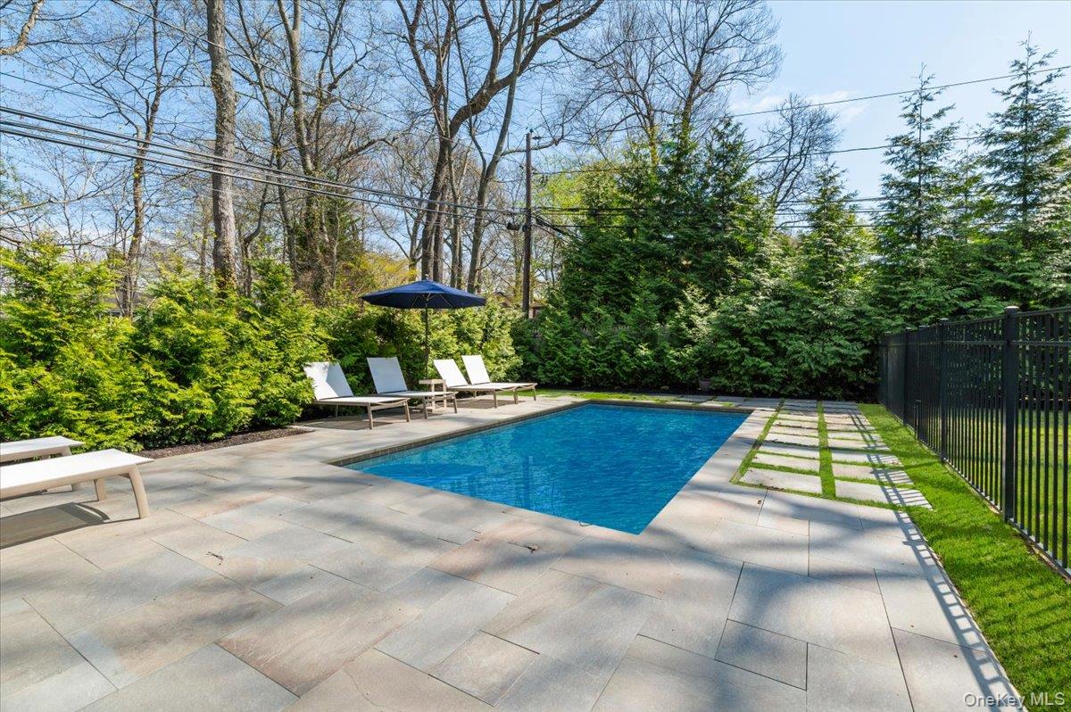 8 Heritage Court Cold Spring Harbor, NY 11724 - Photo 29 of 38 a view of yard with swimming pool and seating space