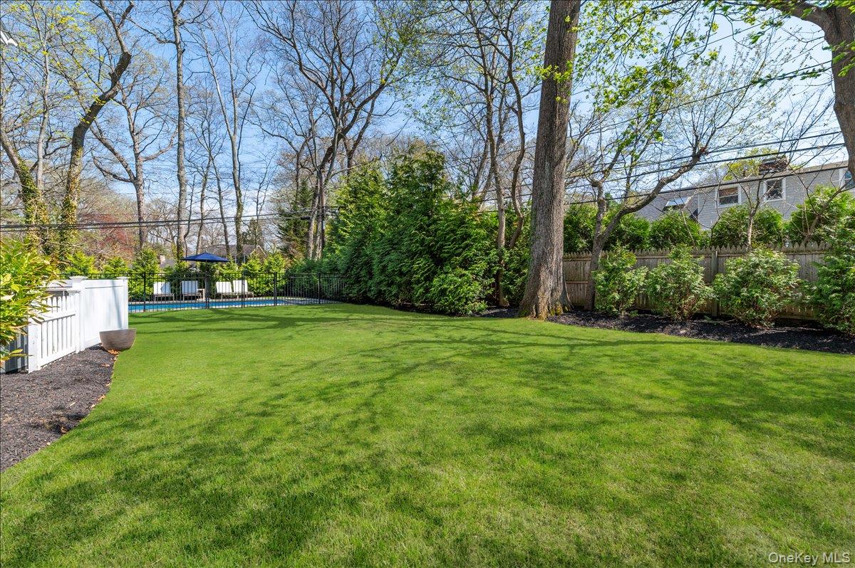 8 Heritage Court Cold Spring Harbor, NY 11724 - Photo 36 of 38 a view of a backyard with large trees