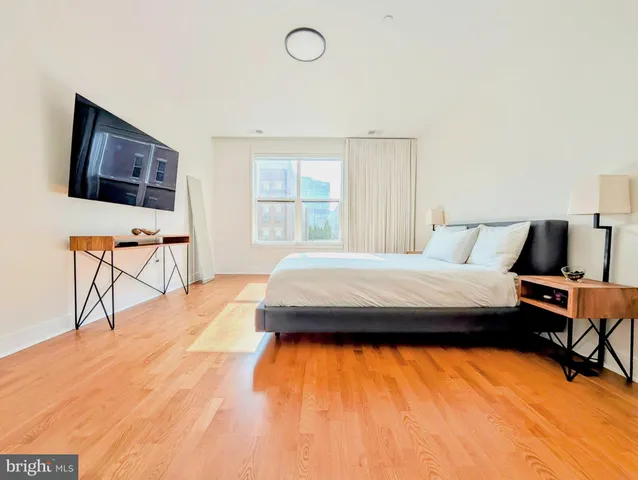 a bedroom with a bed and chair