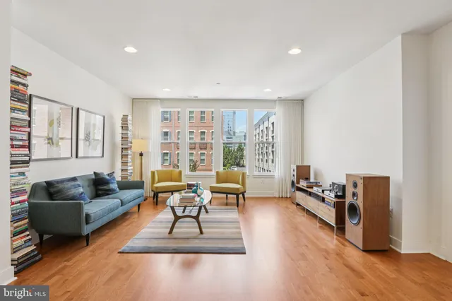 a living room with furniture and a wooden floor