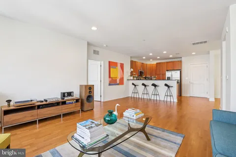 a living room with furniture and a wooden floor