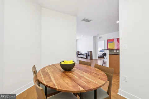 a view of a dining room with a table and chairs
