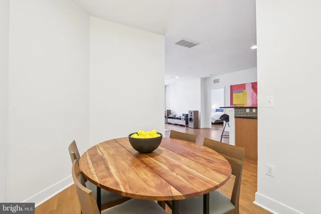 a view of a dining room with a table and chairs