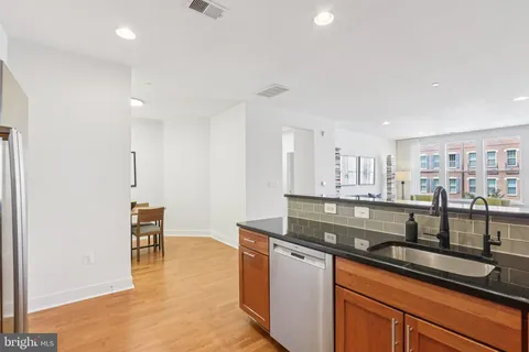 a kitchen with stainless steel appliances granite countertop a sink and cabinets