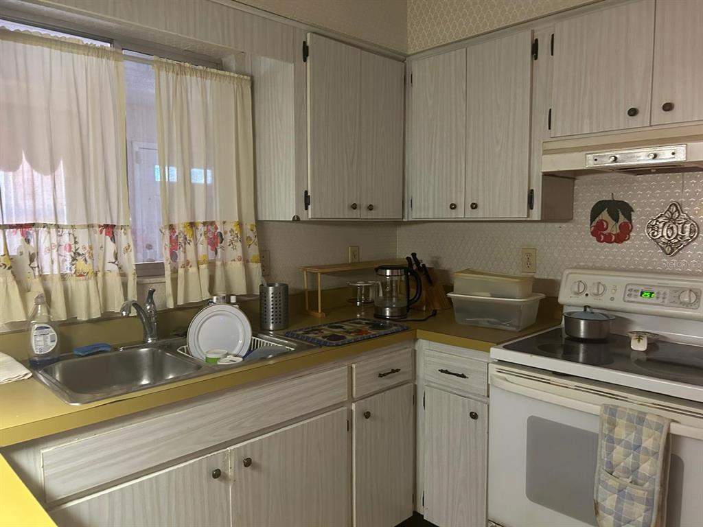 568 Silver Course Loop Ocala, FL 34472 - Photo 14 of 26 a kitchen with a white cabinets and window