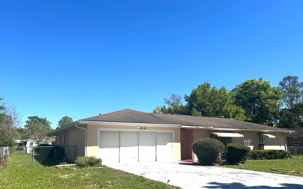 568 Silver Course Loop Ocala, FL 34472 - Photo 23 of 26 a front view of a house with a yard