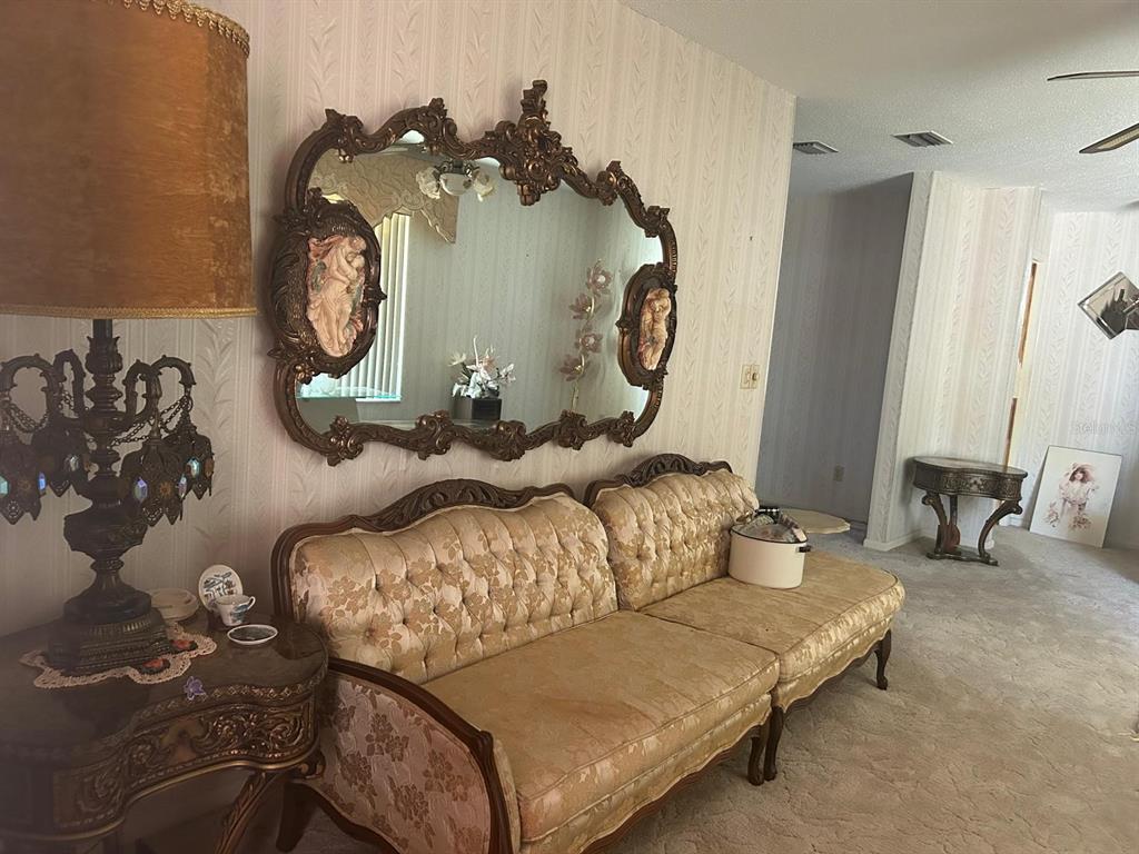 568 Silver Course Loop Ocala, FL 34472 - Photo 4 of 26 a living room with furniture and a clock