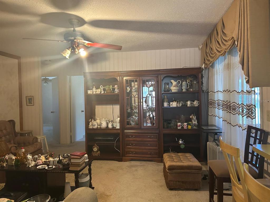 568 Silver Course Loop Ocala, FL 34472 - Photo 5 of 26 a living room with furniture and a floor to ceiling window