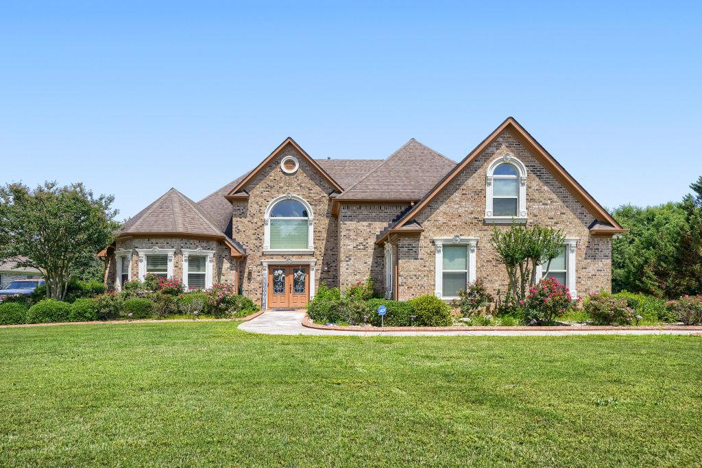345 Masters Club Boulevard Hampton, GA 30228 - Photo 3 of 30 a front view of a house with a yard and potted plants