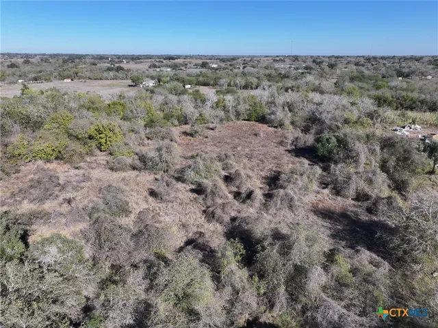 an aerial view of beach and green space