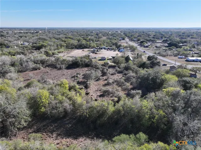an aerial view of house with yard and mountain view in back
