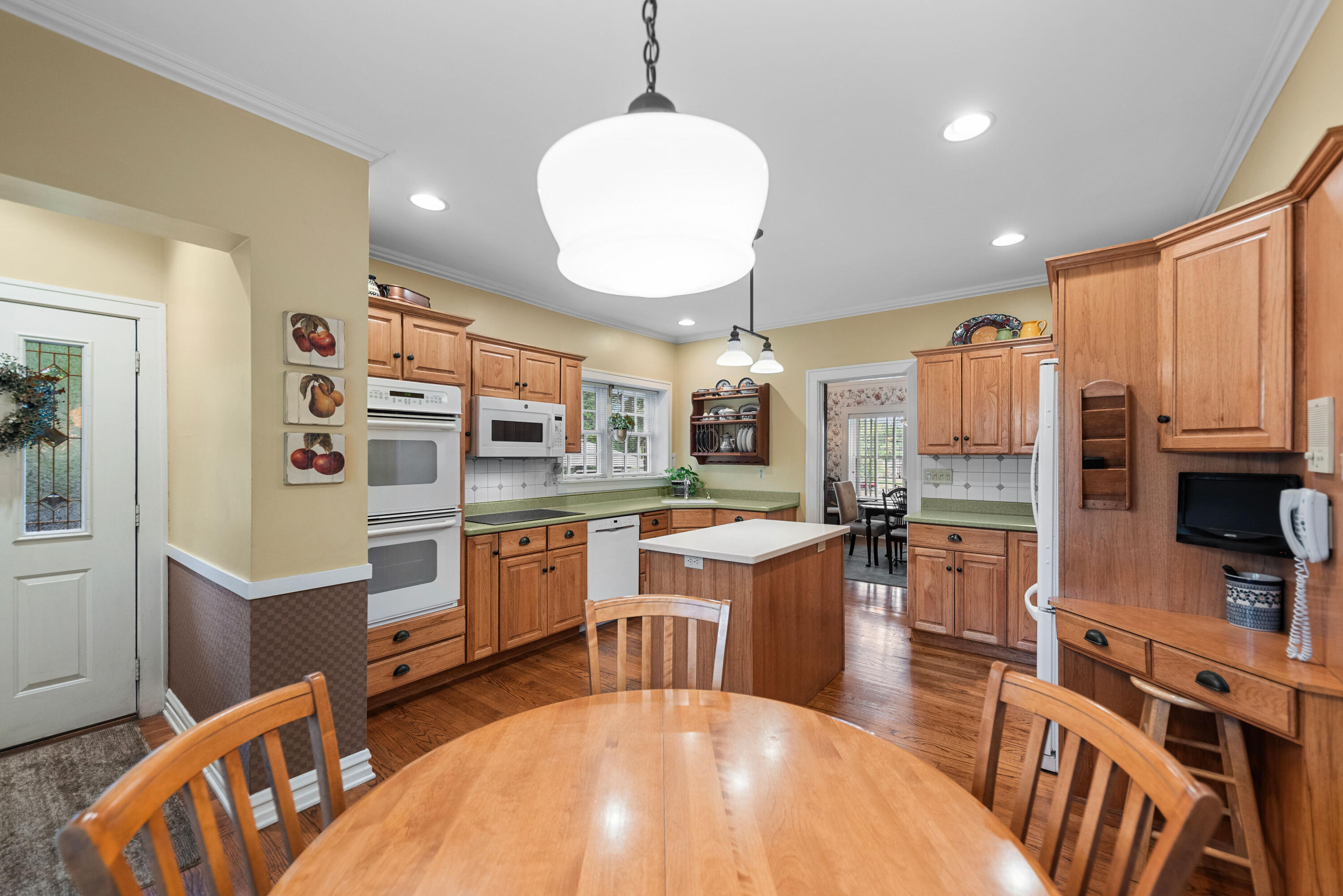 1908 Ridge Road Munster, IN 46321 - Photo 14 of 39 a kitchen with stainless steel appliances wooden floor dining table and chairs