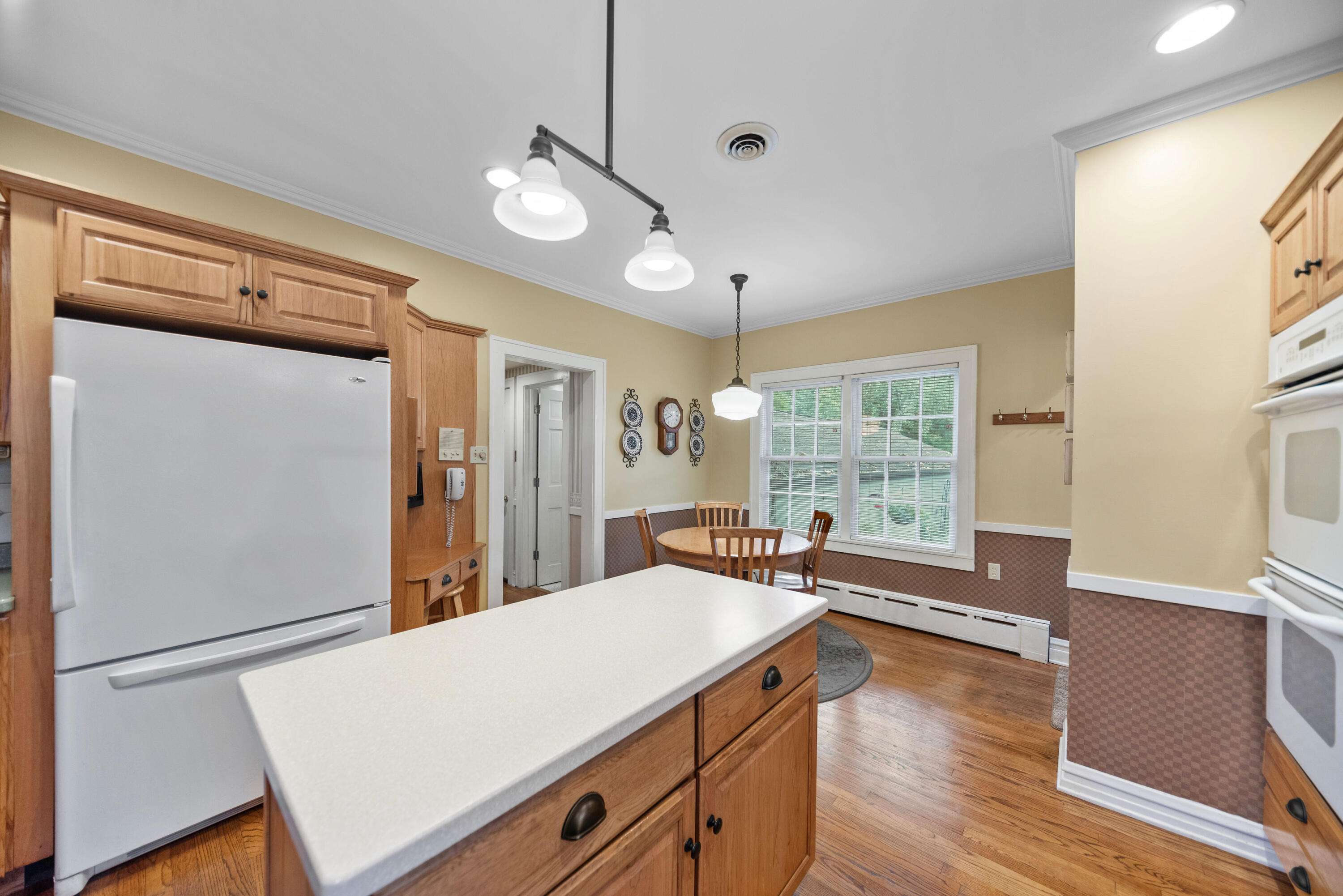 1908 Ridge Road Munster, IN 46321 - Photo 15 of 39 a large kitchen with kitchen island a large counter space wooden floor and stainless steel appliances
