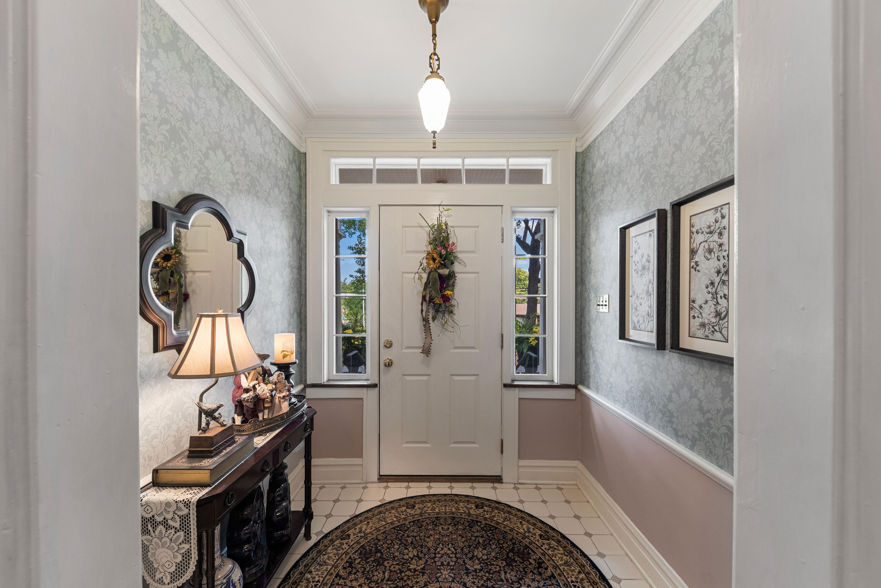 1908 Ridge Road Munster, IN 46321 - Photo 5 of 39 a view of a hallway with entryway dining space and chandelier fan