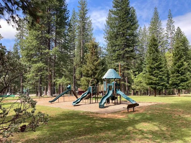 a view of outdoor space with playground and green space