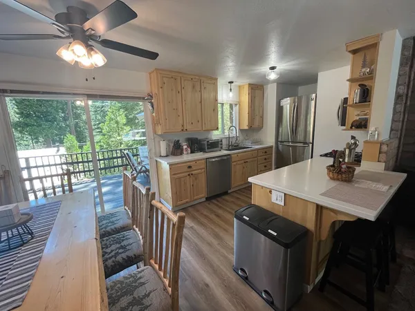 a kitchen with sink stove and wooden floor