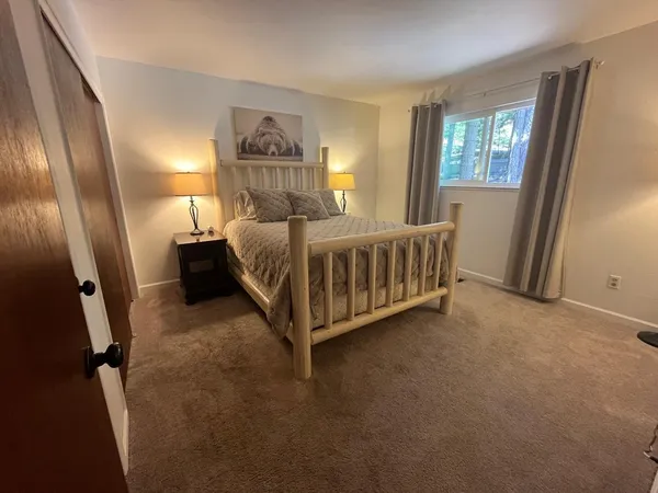 a bed sitting in a room next to a window