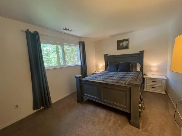 a bed sitting in a room next to a window