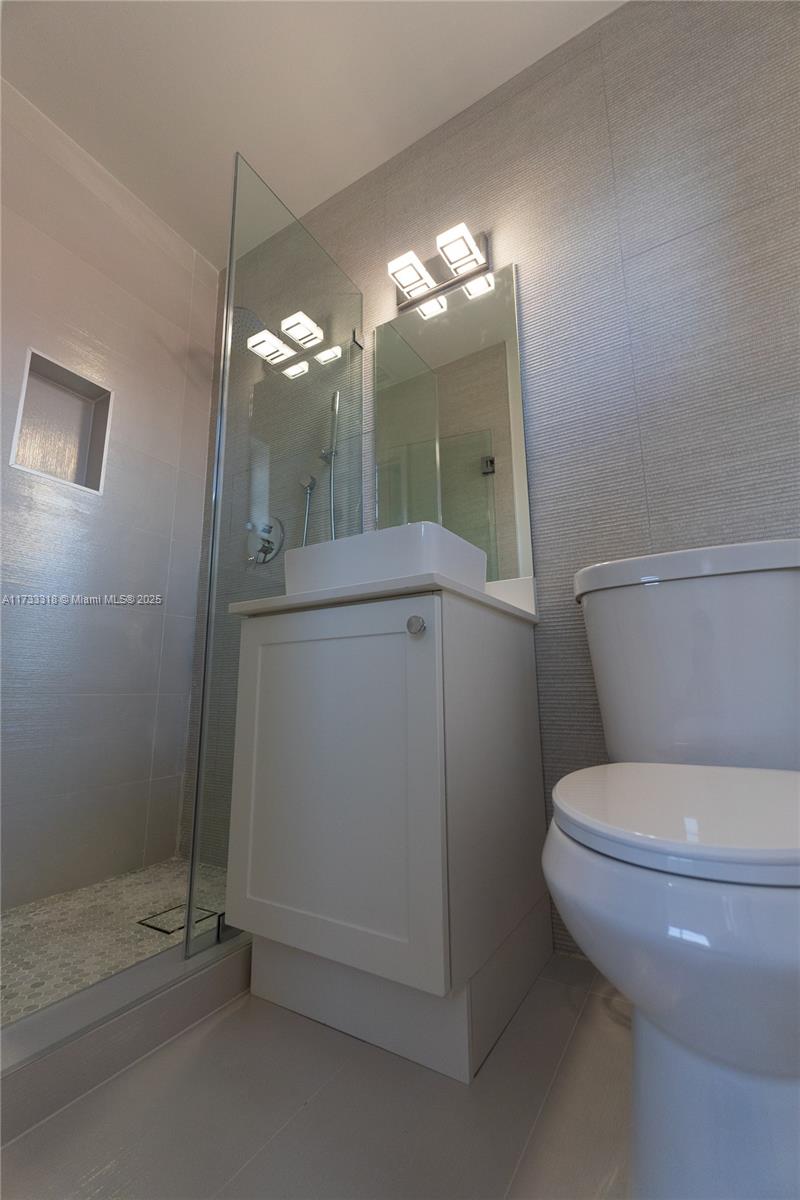 Westchester Miami, FL 33155 - Photo 13 of 17 a white toilet sitting next to a bathroom sink