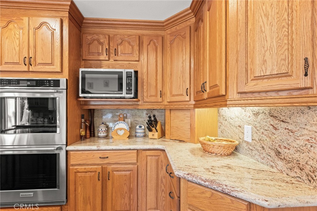 12911 Dean Street Santa Ana, CA 92705 - Photo 17 of 45 a kitchen with granite countertop white cabinets and stainless steel appliances