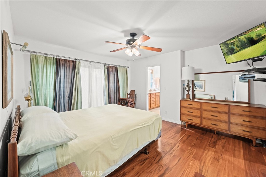 12911 Dean Street Santa Ana, CA 92705 - Photo 24 of 45 a spacious bedroom with a bed and a flat screen tv