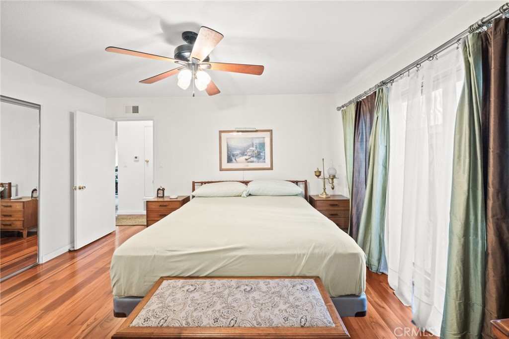 12911 Dean Street Santa Ana, CA 92705 - Photo 25 of 45 a spacious bedroom with a large bed and a chandelier