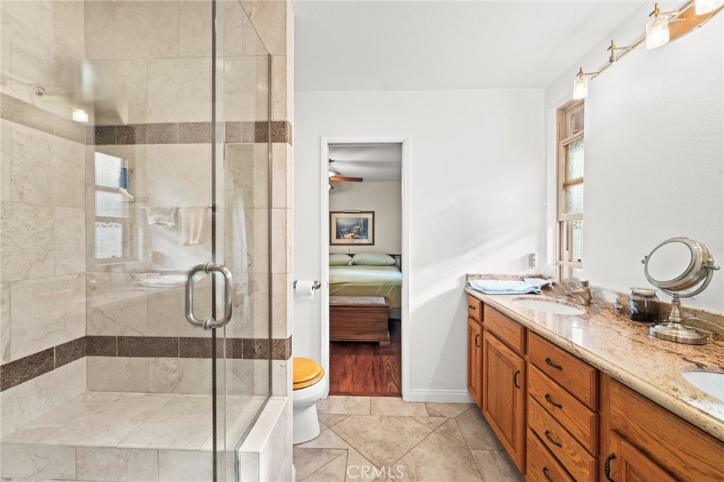 12911 Dean Street Santa Ana, CA 92705 - Photo 27 of 45 a bathroom with a granite countertop sink and a mirror