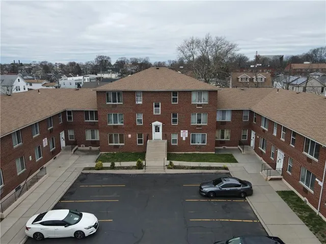 a view of a street with cars parked in front of it