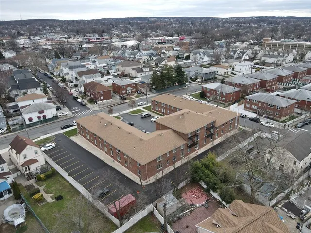 an aerial view of a residential apartment building with a city view