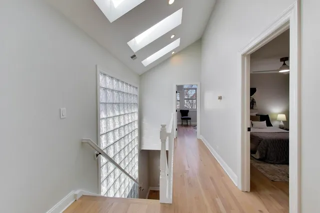a view of entryway and hall with wooden floor