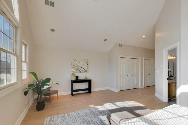 a bedroom with furniture and a potted plant