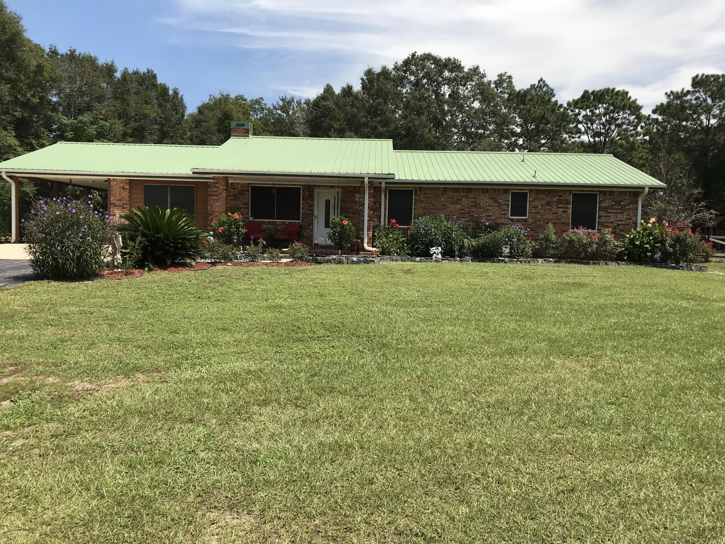 a front view of a house with yard porch and furniture