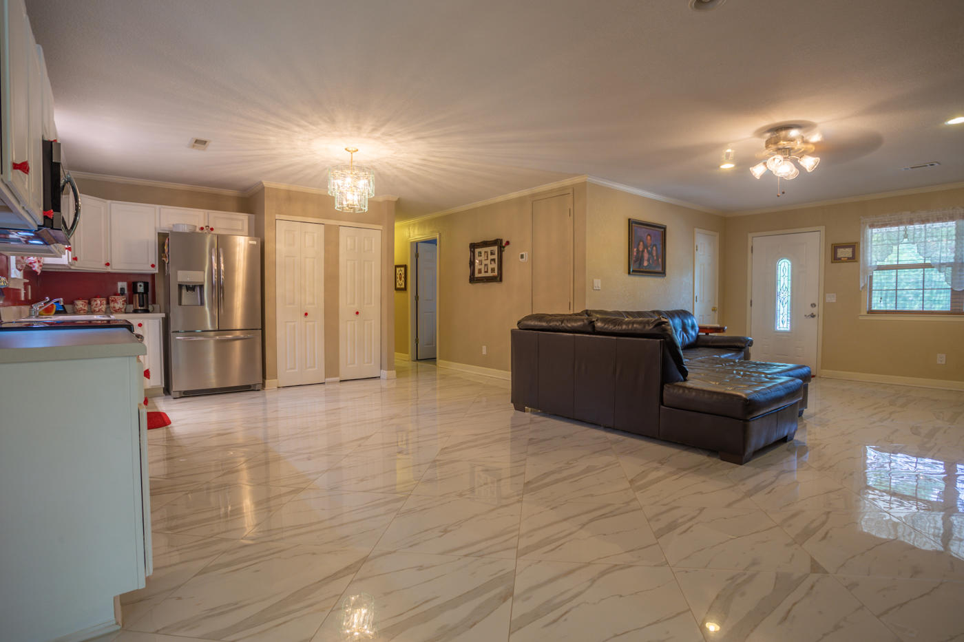 5621 Buckward Road Baker, FL 32531 - Photo 12 of 41 a living room with furniture and a chandelier