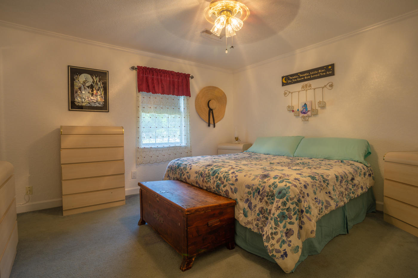 5621 Buckward Road Baker, FL 32531 - Photo 17 of 41 a bedroom with a bed and a chandelier