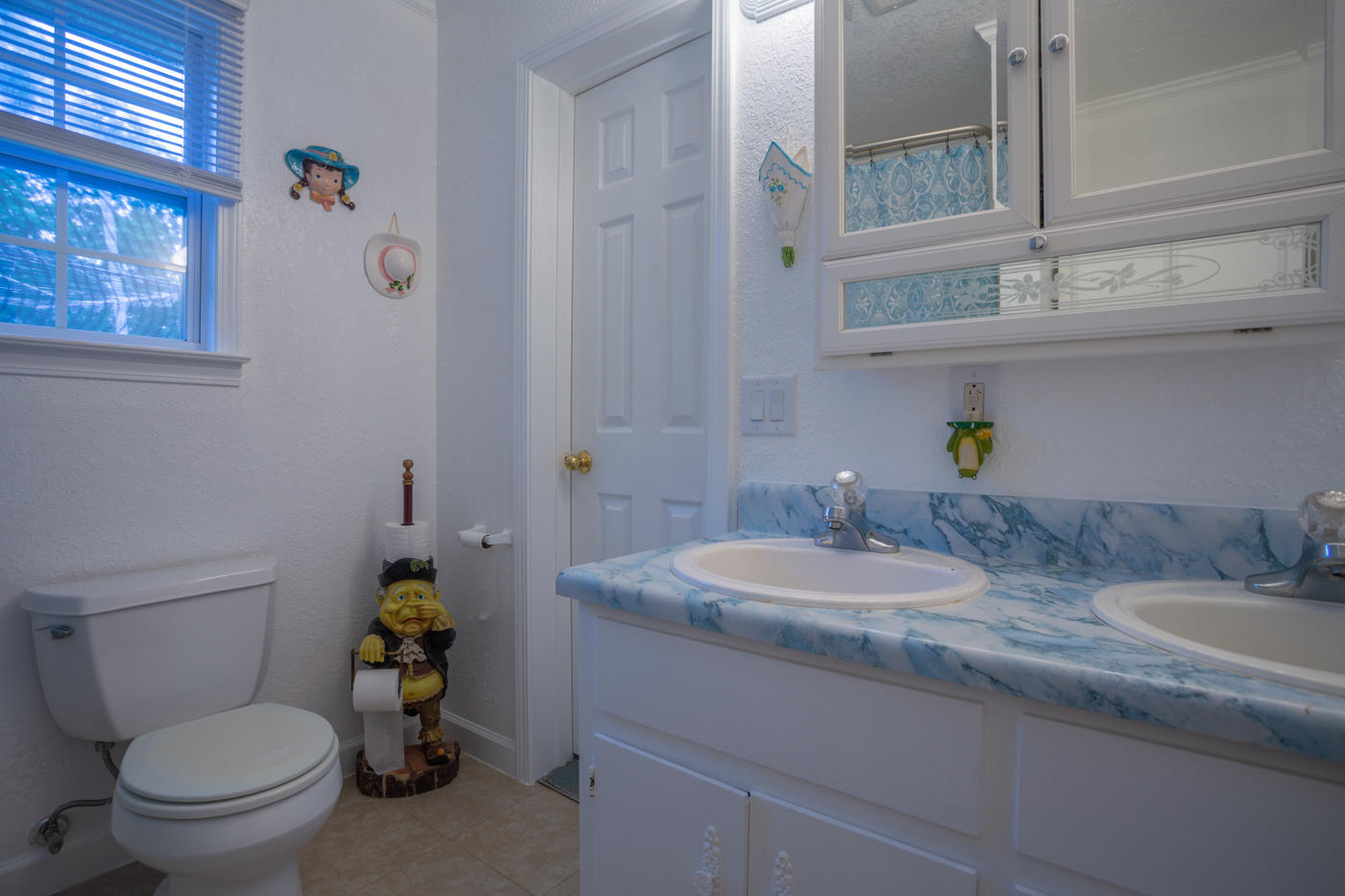 5621 Buckward Road Baker, FL 32531 - Photo 18 of 41 a bathroom with a granite countertop toilet sink and mirror